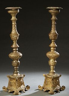 Pair of Gilt Bronze Candlesticks, late 19th c., with knopped floral and Egyptian masque supports, to a tripodal leaf and Egyptian masque decorated bas