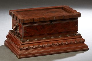 Victorian Carved Walnut Glove Box, late 19th c., with a dentillated lid over lions' head sides, on a stepped dentillated base, the interior lined in c