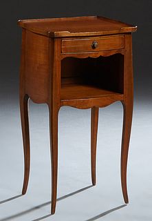 French Louis XV Style Carved Cherry Bowfront Nightstand, 20th c, the 3/4 galleried top over a frieze drawer and open storage, on square tapered cabrio