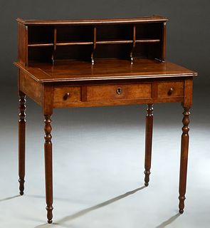 French Louis Philippe Carved Walnut Writing Table, 19th c., the galleried superstructure back with eight cubby holes, over three frieze drawers, on tu