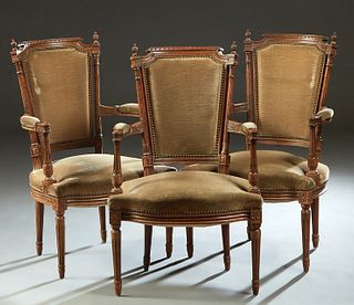 Set of Three Carved Beech Louis XVI Style Fauteuils, late 19th c., the carved canted upholstered back over curved upholstered arms, to a bowed seat, o