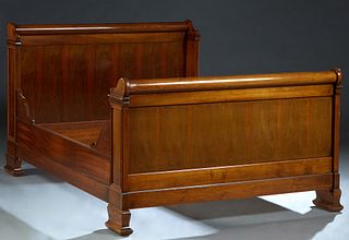 French Louis Philippe Carved Walnut Double Bed, 19th c., the curved scrolled post headboard, on flat pilasters, to stepped block feet, to wooden brack
