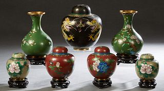Group of Seven Chinese Cloisonne Pieces, 20th c., consisting of six baluster vases and a baluster covered jar, five pieces on carved mahogany stands, 