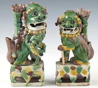 Pair of Chinese Kangxi Polychromed Porcelain Foo Dogs Bud Vases, c. 1700, the bottom with a tag from Henry Stern Antiques, New Orleans.H.- 7 3/4 in., 