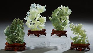 Group of Four Chinese Carved Jade Figural Groups, 20th c., of birds and flowers, on custom carved mahogany stands, Largest- H.- 8 1/4 in., W.- 6 3/8 i