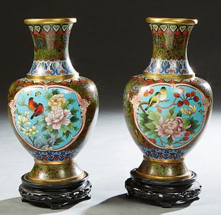 Pair of Elaborate Chinese Cloisonne Baluster Vases, 20th c, with reserves of birds and flowers, on carved ebonized wood stands, H.- 12 in., Dia.- 7 in