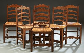Set of Six French Provincial Carved Walnut Rush Seat Dining Chairs, 20th c., the arched ladder back over a trapezoidal rush seat, on reeded tapered sq