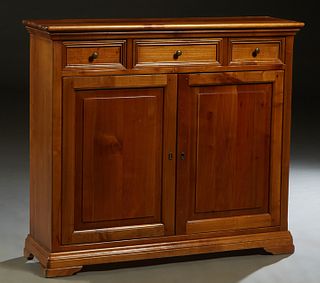 French Louis Philippe Carved Cherry Sideboard, early 20th c., the rectangular rounded edge top above double fielded panel cupboard doors, on a stepped