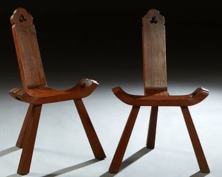Pair of Spanish Provincial Carved Mahogany Chairs, 20th c., with carved trefoil cutouts on the backs and curved seats, on reeded tripodal legs, H.- 30