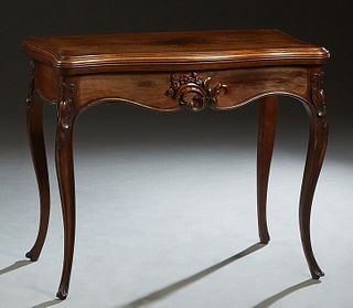 French Louis XV Style Carved Walnut Games Table, 20th c., the stepped serpentine top opening to a gilt tooled baize inset playing surface, over a bowe