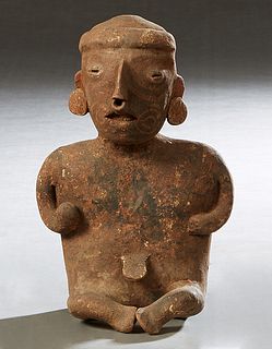 Pre-Columbian Pottery Figure, of a seated man with a ball in his right hand, with traces of original paint, H.- 9 1/2 in., W.-6 in., D.- 4 3/4 in. Pro