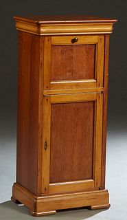 French Louis Philippe Style Carved Cherry Nightstand, 20th c., the rounded edge and corner top over a fall front door enclosing shelves, above a long 