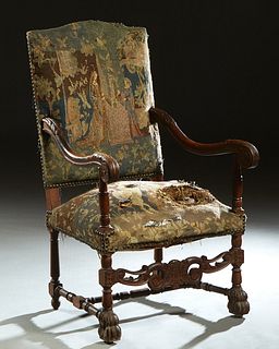 French Carved Walnut Fauteuil a la Reine, 19th c., the arched rectangular canted back over a cushioned seat flanked by scrolled arms, on turned and bl