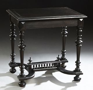 French Henri II Style Carved Ebonized Walnut Writing Table, c. 1880, the stepped rectangular top over a wide skirt, on turned tapered legs, joined by 