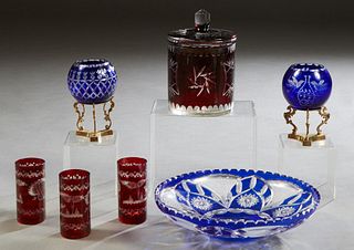 Seven Pieces of Bohemian Cut-to-Clear Items, 20th c., consisting of a ruby decanter and three glasses; a ruby biscuit barrel; two cobalt blue bowls on