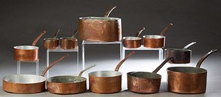 Group of Twelve Pieces of French Copper Cookware, late 19th c., with iron handles, consisting of eleven circular sauce pans, and an oval daubiere, Dau