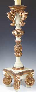 Carved Italian Style Wooden Gilt and Polychromed Candlestick, 20th c., with a knopped support, to a stepped square base on four legs, now wired as a l
