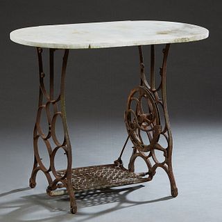 White Marble Top Patio Table, 20th c., the rounded side white marble on a cast iron sewing machine base, H.- 29 3/8 in., W.- 35 1/2 in., D.- 18 1/2 in