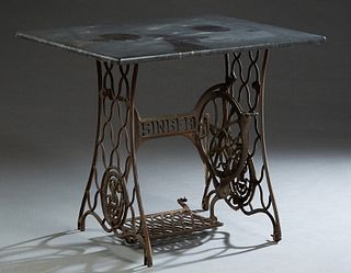 Black Marble Top Patio Table, early 20th c., the rectangular figured marble over a "Singer" sewing machine base, H.- 29 1/2 in., W.- 34 1/2 in., D.- 2