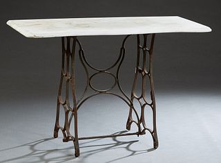 Patinated Bronze Iron Marble Top Table, 20th c., the circular man made marble over an iron top with a dentillated border, on curved bronze legs joined