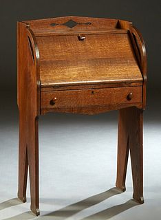 Diminutive Mission Oak Slant Front Secretary, c. 1910, possibly Liberty & Co, London, the interior fitted with a letter slot, on flat tapered trestle 
