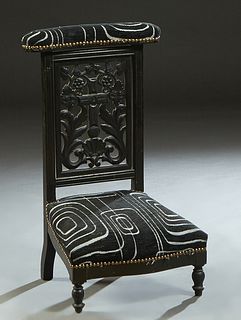 French Carved Walnut Prie Dieu, 19th c., the curved upholstered arm rest over a pierced floral and cruciform splat, to a bowed trapezoidal seat on tur