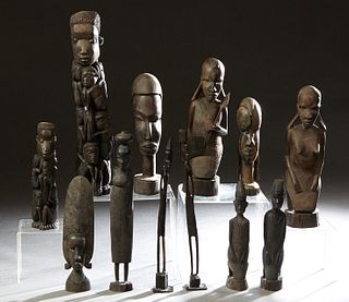 Group of Twelve African Carved Wood Figures, 20th c., consisting of a man with children; a warrior with a spear and shield; two busts; a fertility fig