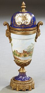Sevres Style Bronze Ormolu Mounted Covered Porcelain Vase, 20th/21st c., in cobalt blue with gilt decoration, the bronze finialed cover over sloping s