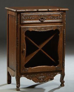 French Provincial Carved Oak Wine Cabinet, 20th c., the rounded corner and edge top over a frieze drawer above a cupboard door with a long iron fiche 