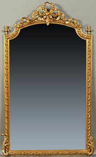 French Louis XVI Style Gilt and Gesso Overmantle Mirror, late 19th c., the arched top with a bow and garland surmount over an arched wide beveled mirr