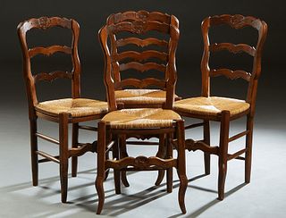 Set of Four French Provincial Carved Beech Rush Seat Chairs, 20th c., the arched ladder back over a rush slip seat, on cabriole legs joined by turned 