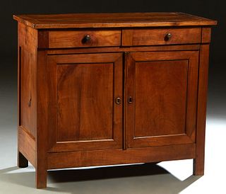French Louis Philippe Carved Walnut Sideboard, late 19th c., the rectangular top over two frieze drawers above double cupboard doors, on a plinth base