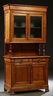 French Louis Philippe Carved Cherry Buffet a Deux Corps, 19th c., the ogee rounded corner crown over double glazed doors, on turned tapered columnar s