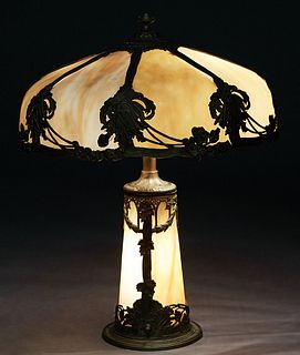 American Gilt Spelter Art Glass Lamp, early 20th c., with a circular curved eight panel caramel slag glass shade, on a tapered two panel curved carame