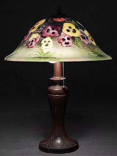 Art Glass Lamp, 20th c., the frosted reverse painted pansy decorated bell shade on a bronze patinated tapered iron support, to a circular relief base 