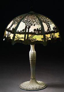 American Polychromed Spelter Lamp, early 20th c., with a six panel curved blue and purple slag glass shade with a wide border of green glass within a 