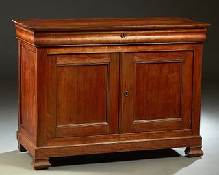French Louis Philippe Carved Cherry Sideboard, 19th c., the rounded edge and corner top over a long frieze drawer above setback double cupboard doors,