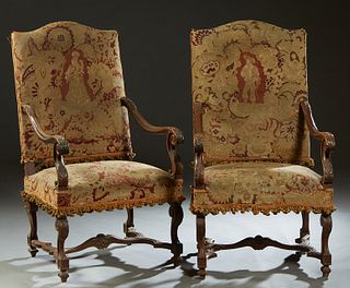 Pair of Louis XIV Style Carved Walnut Fauteuils a la Reine, 19th c., the canted arched upholstered back over acanthus carved scrolled arms, to a trape