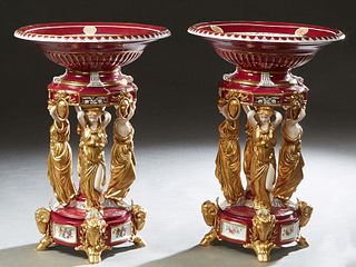 Pair of Meissen Style Porcelain Center Bowls, 20th/21st c., the gilt and floral decorated magenta bowl upheld by four female caryatids, on a gilt deco