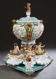 Meissen Style Porcelain Centerbowl, 20th/21st c., the pale blue lid with a putto handle over sides with putti holding garlands, and oval relief reserv