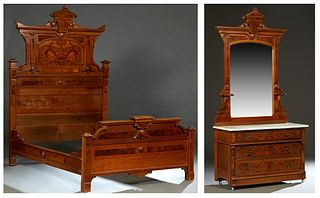 American Eastlake Two Piece Carved Walnut Bedroom Suite, c. 1890, consisting of a highback Bed, the stepped arched headboard with a central keystone, 
