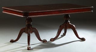 Carved Mahogany Chippendale Style Double Pedestal Dining Table, 20th c., the gadrooned edge top on urn form supports to tripodal ball and claw feet, w