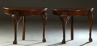 Pair of Georgian Style Carved Mahogany Demilune Console Tables, 20th c., with a center drawer in each, on carved cabriole legs with paw feet and a ste