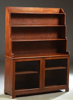 English Style Carved Mahogany Etagere Sideboard, 20th c., with three graduated shelves over a base with double wire mesh cupboard doors, on block feet