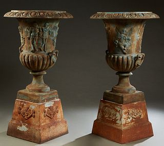 Pair of Large Cast Iron Campana Form Garden Urns, 20th c., the relief rim over side with relief classical figures, on a socle support to a stepped tap