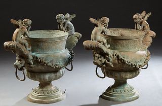 Pair of Patinated Bronze Figural Baluster Garden Urns, 20th c., with lion head ring handles, and two putti with their heads in their hands, over flora
