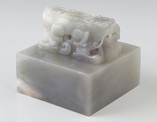 Chinese Carved White Jade Seal, 19th c., with a double Foo lion handle, the underside with relief carved chop marks, presented in a fitted blue cloth 