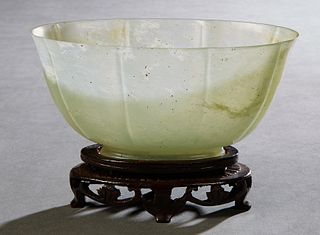 Chinese Carved Jade Oval Footed Bowl, early 20th c., on a carved mahogany stand, H.- 2 5/8 in., W.- 5 1/2 in., D.- 3 in. Provenance: Palmira, the Esta