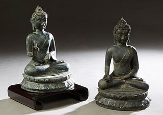 Pair of Chinese Patinated Bronze Seated Buddha Figures, 20th c., on a double lotus throne, H.- 14 in., Dia.- 8 1/2 in. Provenance: Palmira, the Estate