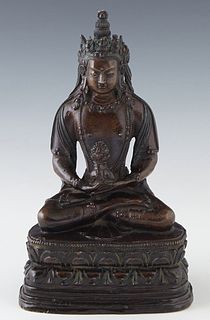 Oriental Patinated Bronze Tara Buddha Figure, 19th c., seated cross legged on a stepped cushion base, H.- 9 3/4 in., W.- 5 1/2 in., D.- 4 in.
